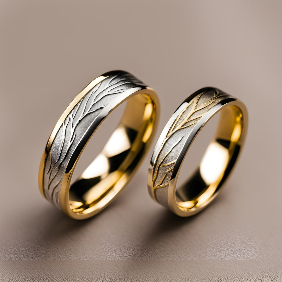 A pair of men's and women's custom wedding rings with a nature inspired tree and branch design in two-tone gold from Rare Earth Jewelry.