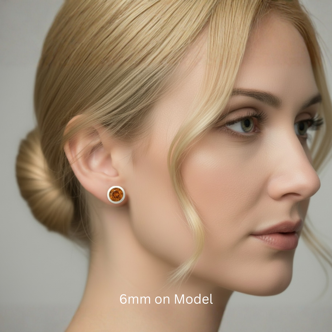 6mm orange topaz stud earring on female ear contemporary matte bezel setting unisex minimalist design | Rare Earth Jewelry