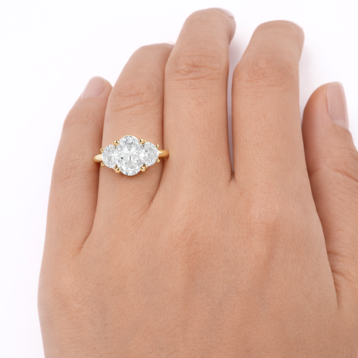 Oval Moissanite Three Stone Engagement Ring with Half Moon Accents Shown on the Hand | Rare Earth Jewelry
