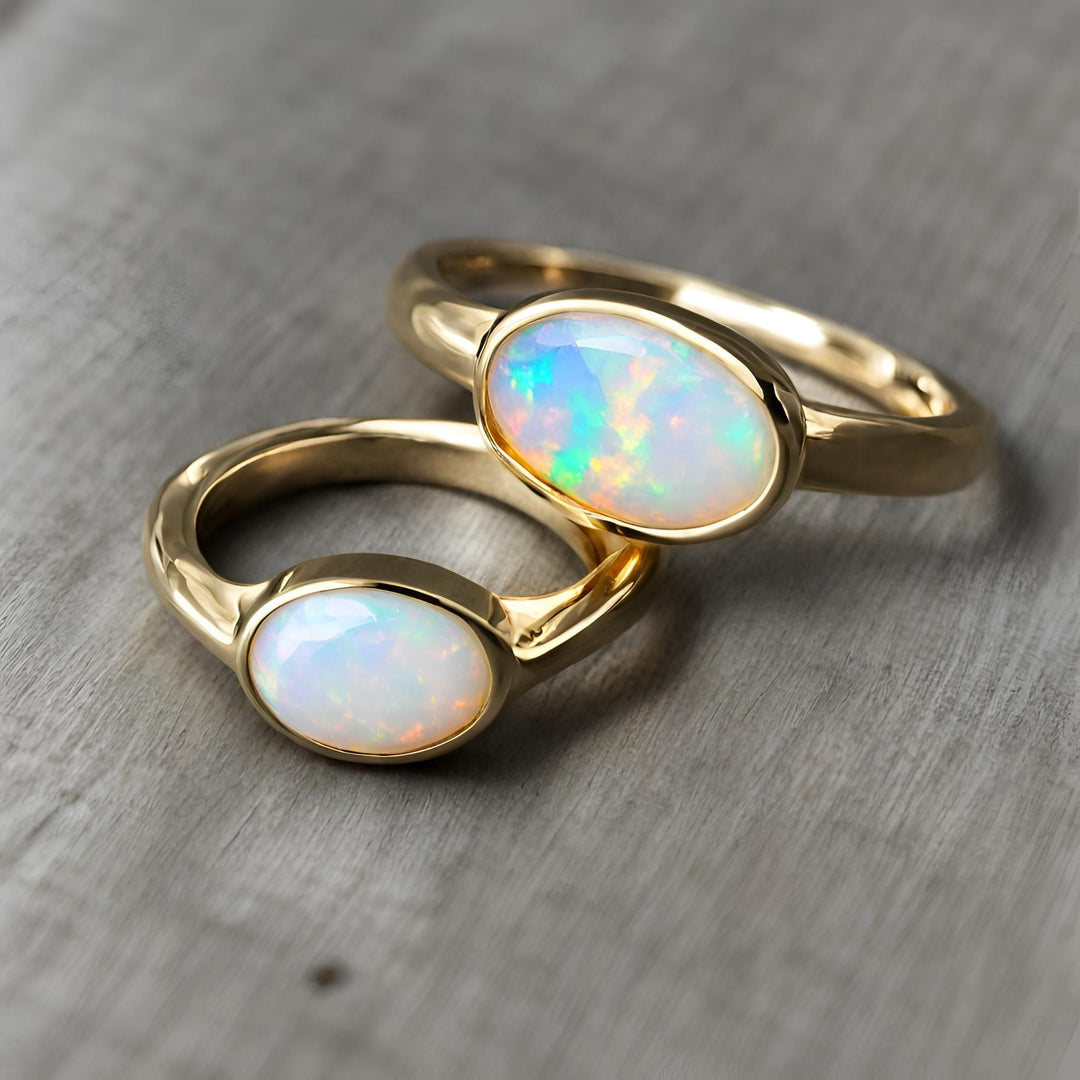 Natural Opal rings in oval bezel settings in a modern minimalist east-west style from Rare Earth Jewelry.