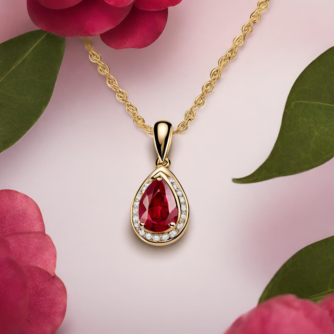 A pear cut ruby pendant in a diamond halo design, 14K gold Ruby necklace from Rare Earth Jewelry.