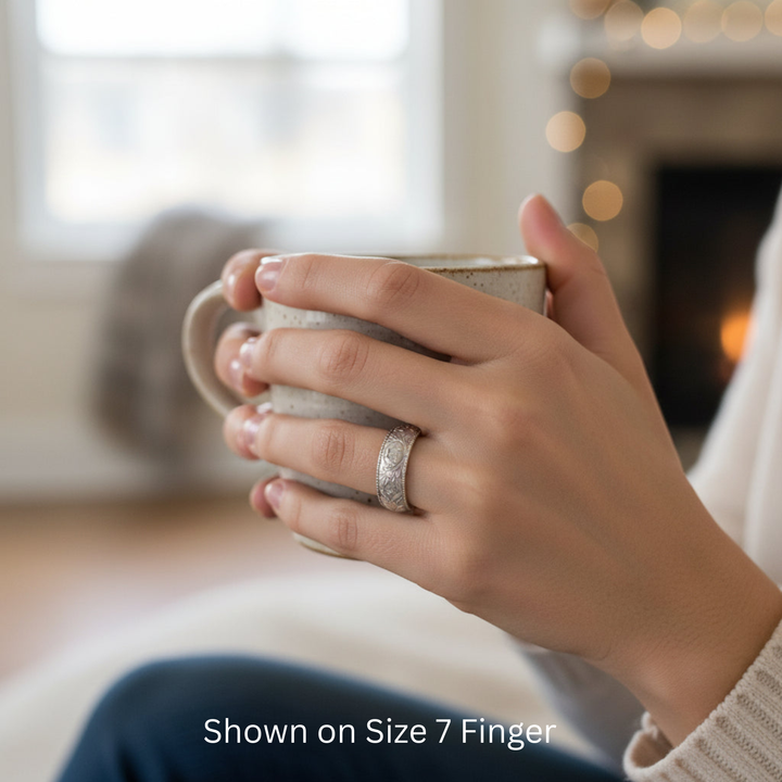 Peony floral engraved wedding band with detailed peony flower design shown on the hand, nature inspired botanical ring, 8mm wide band on size 7 finger | Rare Earth Jewelry