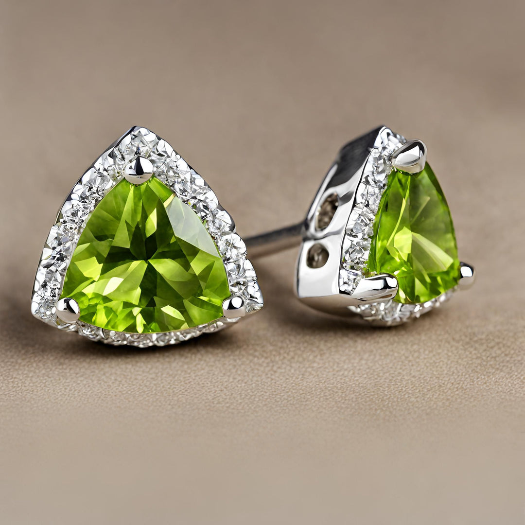 A pair of triangular shaped Peridot earrings in a classic diamond halo design. 14K Peridot trillion cut studs from Rare Earth Jewelry.