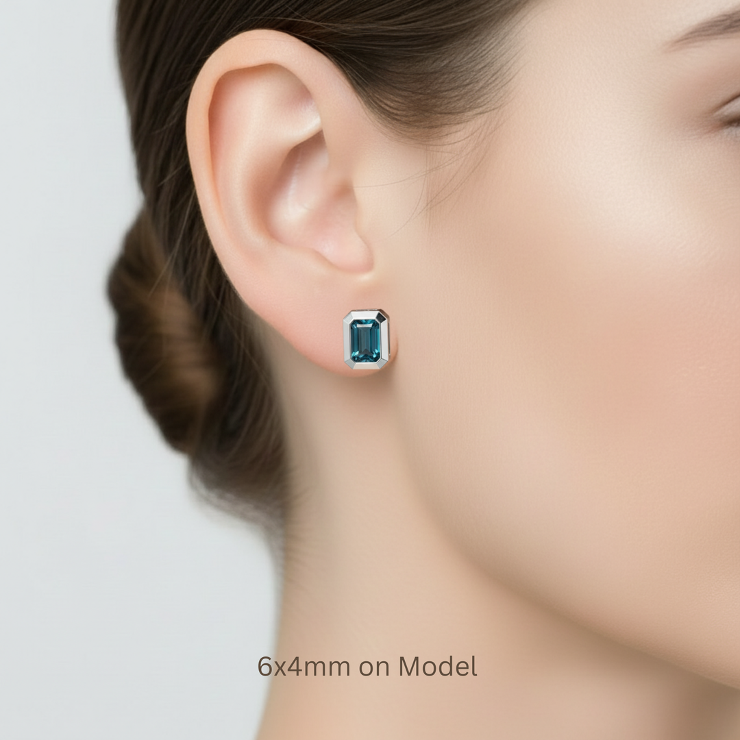 6x4mm petite London Blue Topaz earrings shown on model, small 14K Gold studs with teal blue gemstones | Rare Earth Jewelry