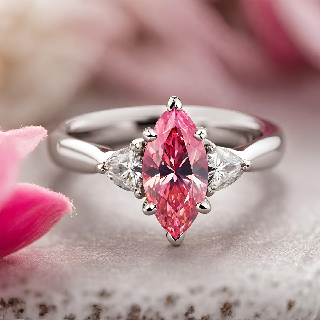 Pink Moissanite ring marquise cut 3 stone engagement ring with trillions from Rare Earth Jewelry.