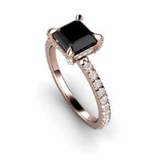 Princess cut Black Diamond engagement ring with claw prongs.  This rose gold setting has hidden diamonds on the gallery.