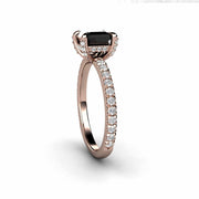 Princess cut Black Diamond engagement ring with diamond prongs on a thin, feminine band with diamond accents.