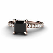 Princess cut Black Diamond ring with natural diamond accents and clar prongs in rose gold.