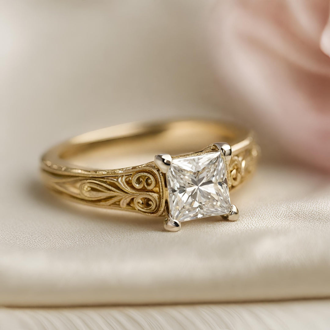 A princess cut diamond engagement ring in a vintage inspired solitaire setting with filigree in 18K Gold from Rare Earth Jewelry.