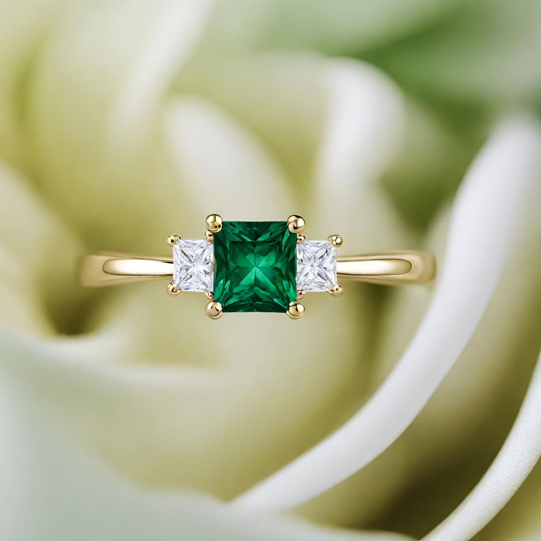 A classic princess cut Emerald 3 stone engagement ring with diamonds from Rare Earth Jewelry.