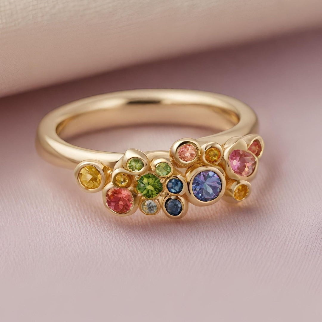 A rainbow sapphire band, 14K multistone ring with bezel set colorful sapphires from Rare Earth Jewelry.