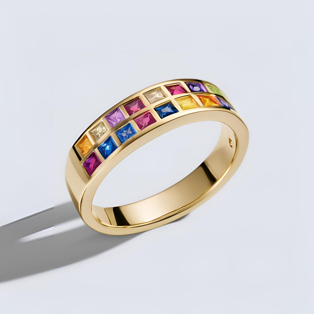 A rainbow sapphire band in yellow gold with two rows of square multi-colored sapphires in a random pattern from Rare Earth Jewelry.