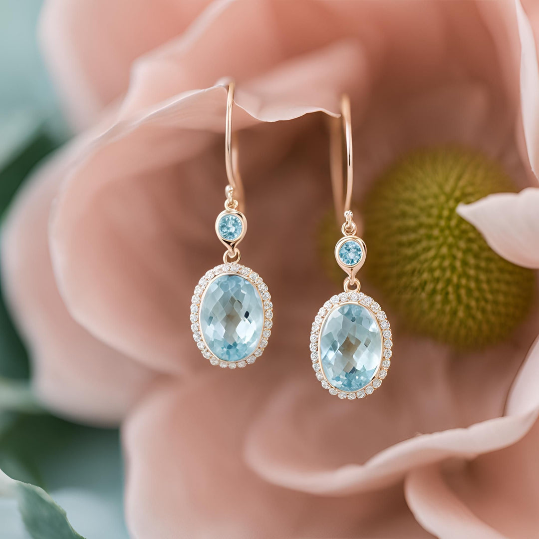 Rose cut oval Aquamarine earrings in a 14K Gold bezel set diamond halo dangle design from Rare Earth Jewelry.