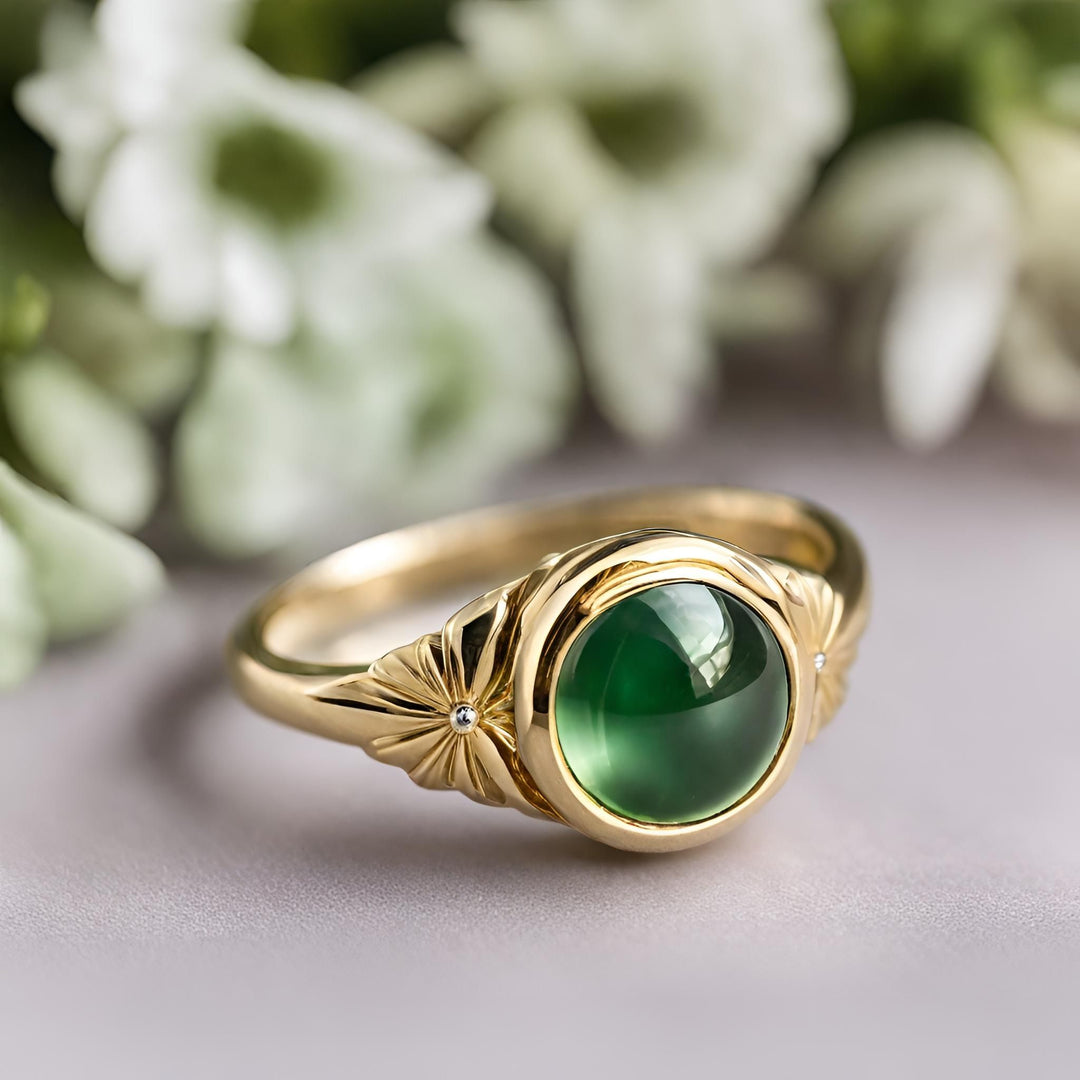 A round green tourmaline ring in a yellow gold floral bezel setting, tourmaline cabochon ring from Rare Earth Jewelry.