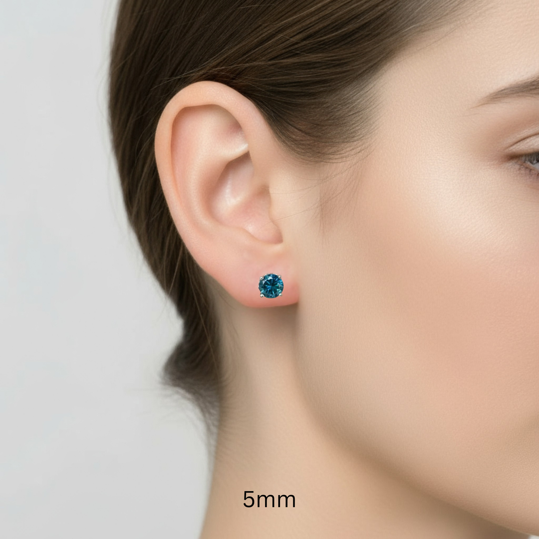 14K Gold London Blue Topaz Earrings, 5mm Natural Blue Topaz Studs Shown on a Model's Ear, Round Blue Gemstone Earrings, December Birthstone Jewelry | Rare Earth Jewelry
