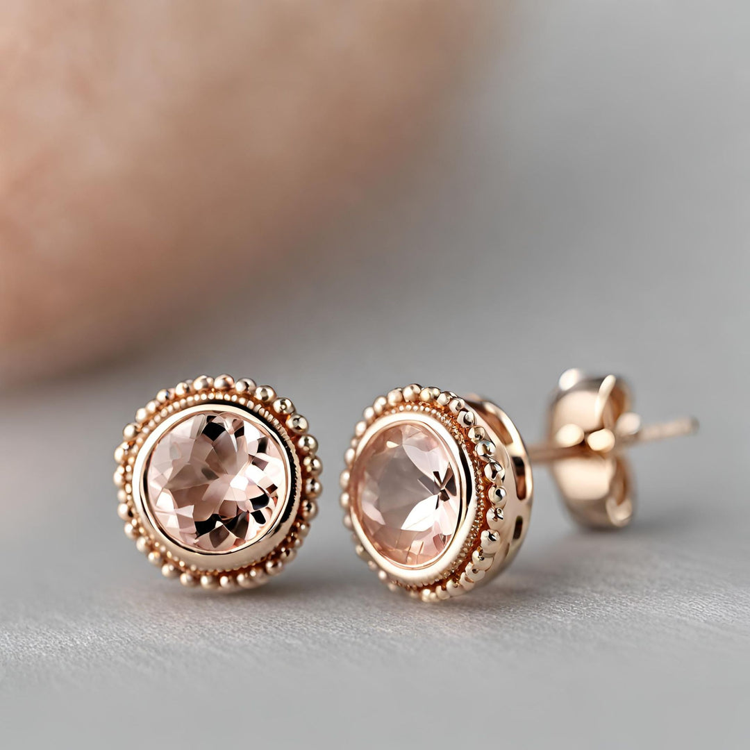 A pair of 14K Rose Gold Round Morganite Earrings in a bezel set stud design with milgrain detailing from Rare Earth Jewelry.