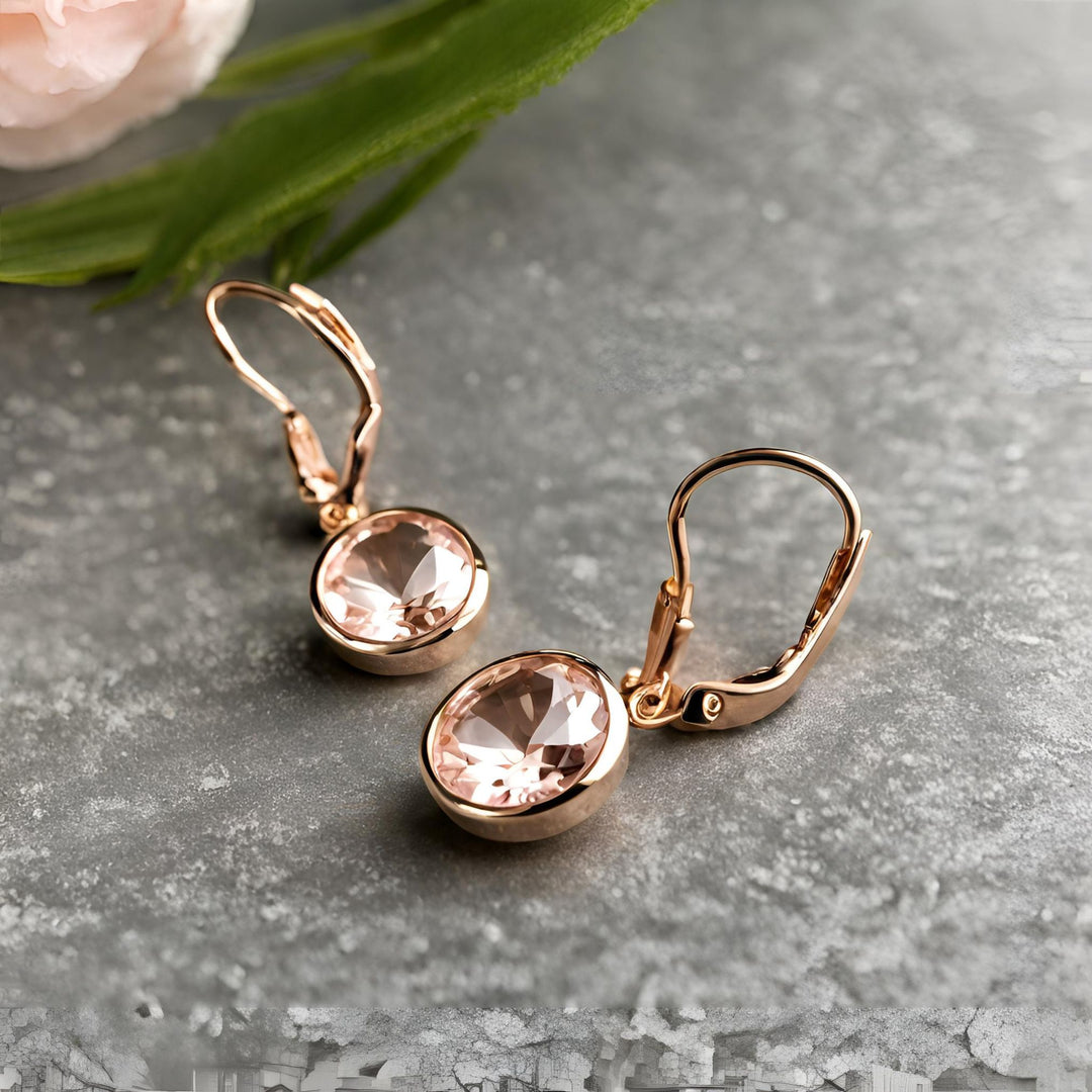 A pair of round Morganite earrings in a 14K Rose Gold dangles bezel set with leverbacks from Rare Earth Jewelry.