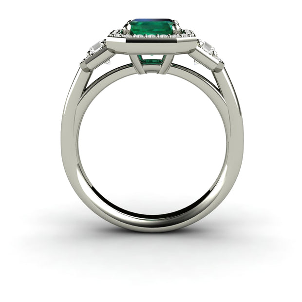 Side view of 3 stone lab grown emerald and diamond engagement ring in white gold.