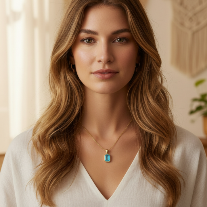 sky blue topaz pendant necklace on model in 14k yellow gold emerald cut light aqua stone | Rare Earth Jewelry