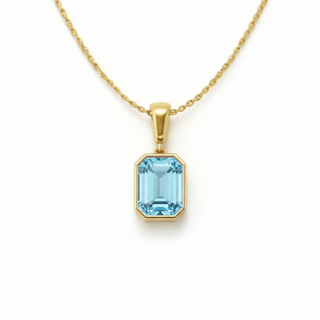 emerald cut sky blue topaz necklace in 14k yellow gold bezel setting light blue gemstone | Rare Earth Jewelry