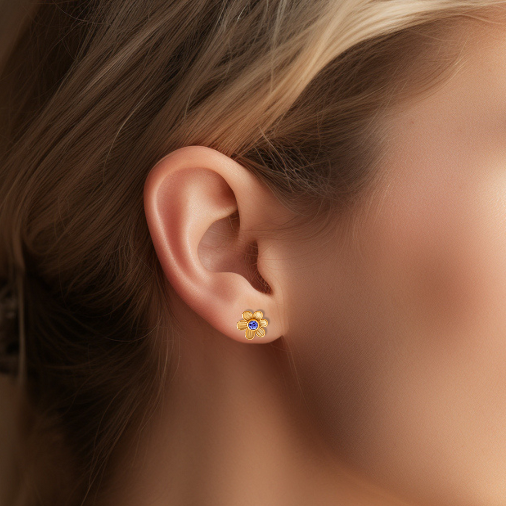 Tanzanite stud earrings in a floral design. Flower shaped Tanzanite earrings on the ear.  Natural gemstone studs in 14K or 18K Gold. December birthstone earrings. Perfect birthday gift or push present. | Rare Earth Jewelry