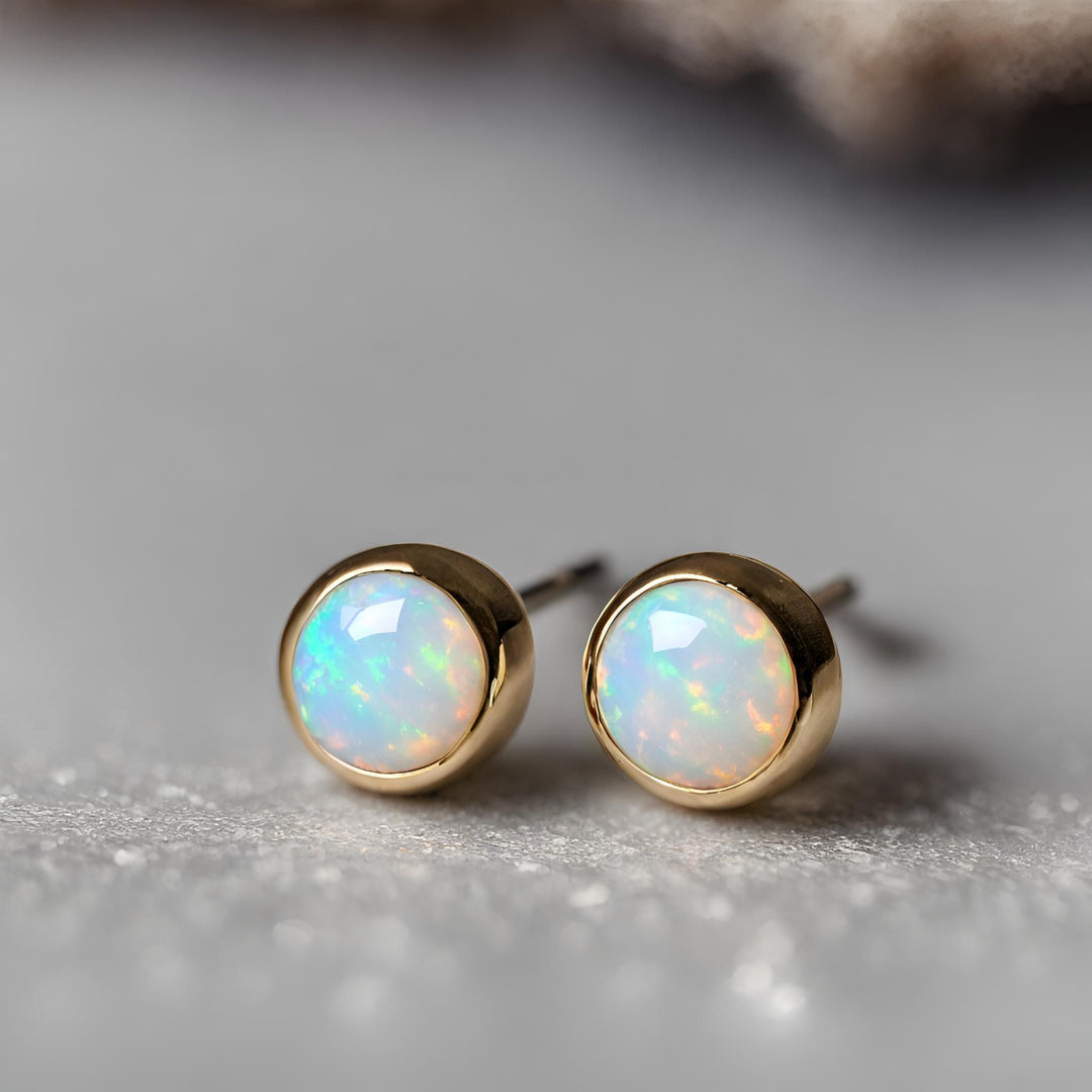 Small round Opal stud earrings in 14K Gold, tiny bezel set Opal earrings from Rare Earth Jewelry.