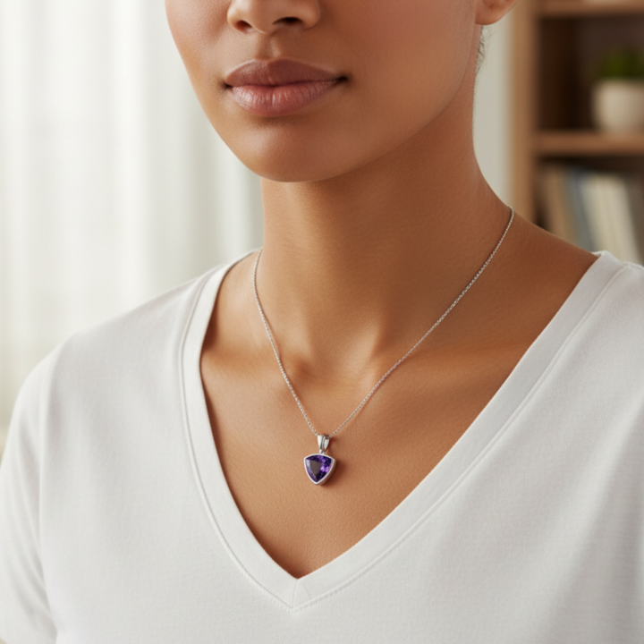 Triangle cut amethyst pendant necklace worn by model in 14K gold bezel setting modern, minimalist unisex design, February birthstone jewelry | Rare Earth Jewelry