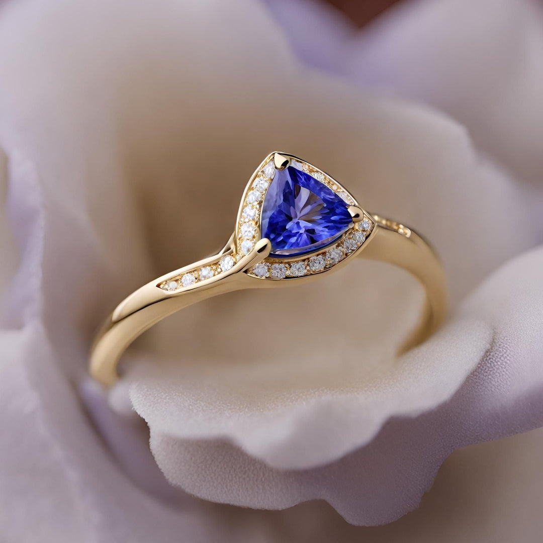 A trillion cut natural tanzanite ring with diamond accents, unique triangle shaped ring in 14K or 18K gold from Rare Earth Jewelry.