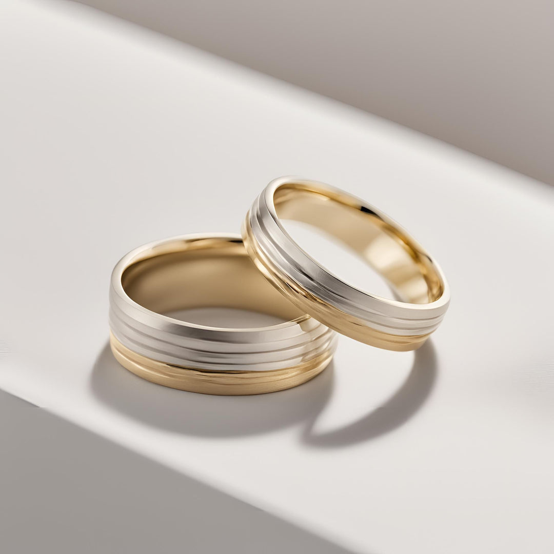 A pair of men's and women's two-tone wedding bands with a ribbed and grooved satin finish wedding rings from Rare Earth Jewelry.