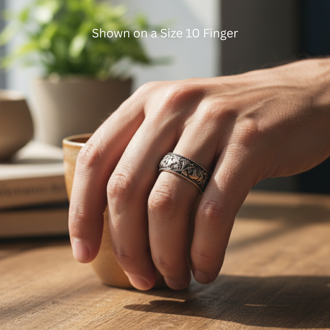 Antique style wedding band with floral design of vines and flowers, 8mm band in 14K White Gold dark patina shown on size 10 finger | Rare Earth Jewelry