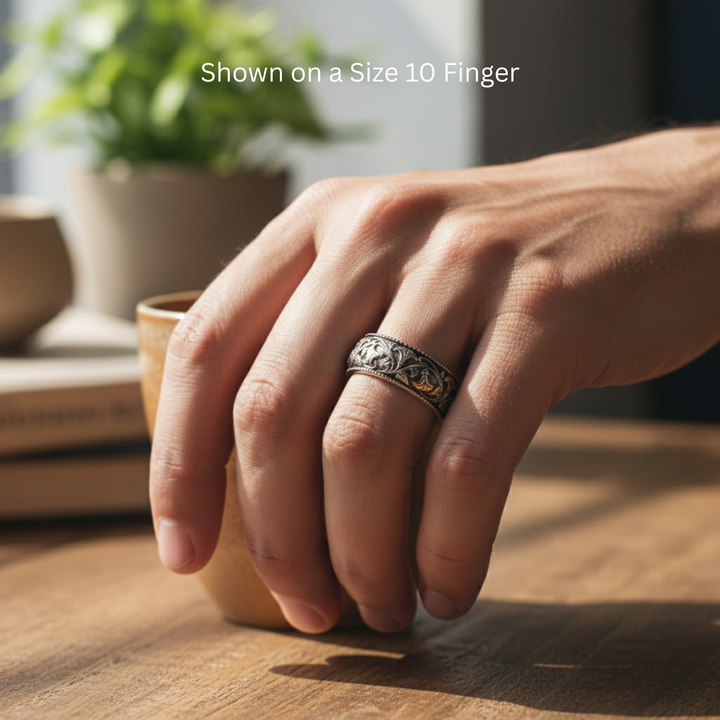 Antique style wedding band with floral design of vines and flowers, 8mm band in 14K White Gold dark patina shown on size 10 finger | Rare Earth Jewelry