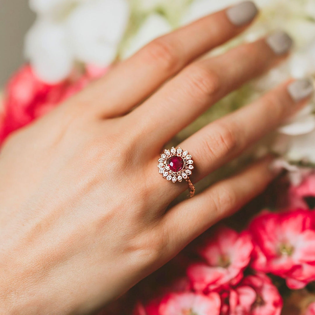 A round ruby ring surrounded by diamonds in a pretty vintage inspired design from Rare Earth Jewelry.