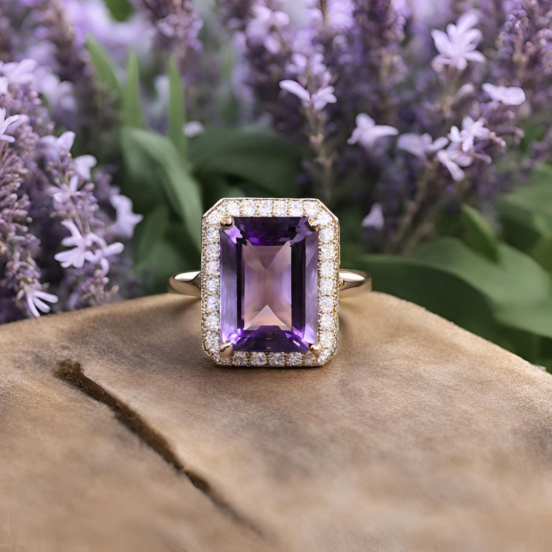 A large emerald cut Amethyst ring with pave set diamond halo, a beautiful statement or cocktail ring from Rare Earth Jewelry.