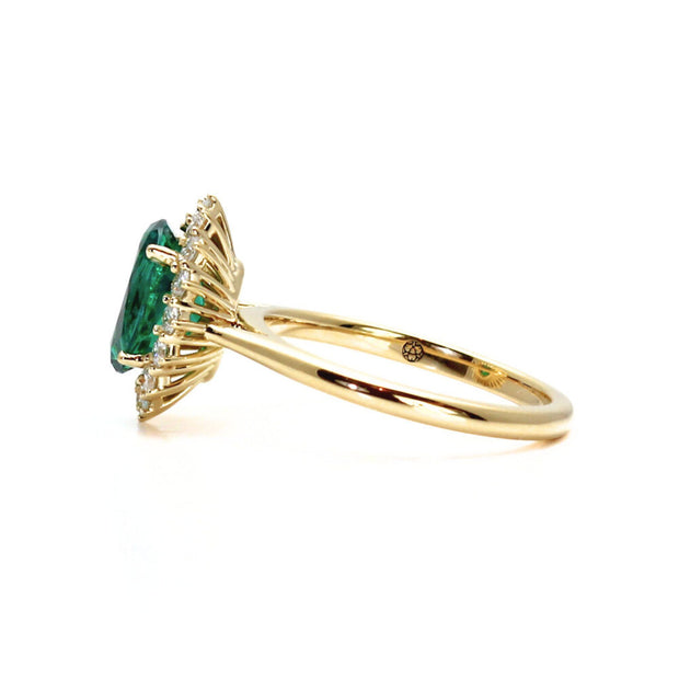 Vintage style oval emerald engagement ring.  May birthstone ring with diamonds.  Side view of ring in yellow gold.
