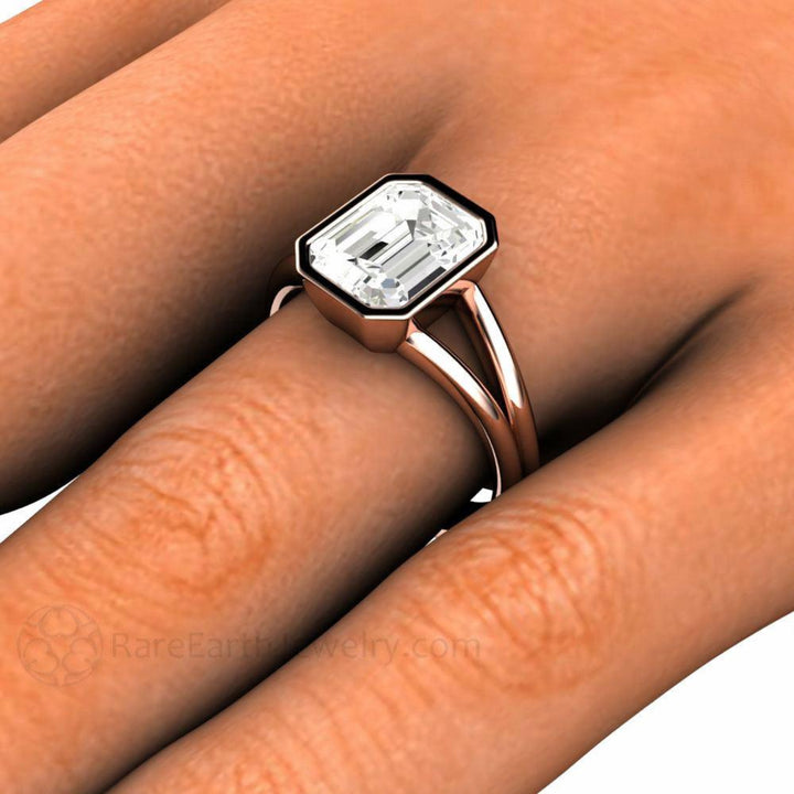 3 Carat Emerald Cut Lab Grown Diamond Engagement Ring on the Finger, Simple Bezel Set Solitaire Design