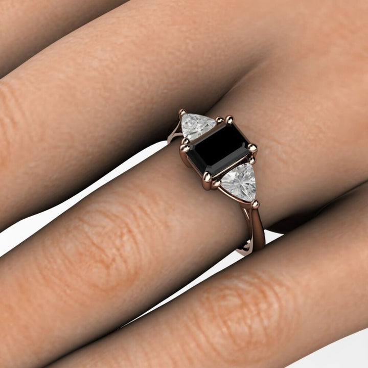 3 Stone Black Spinel Engagement Ring on the Hand, Emerald Cut with White Sapphire Trillions