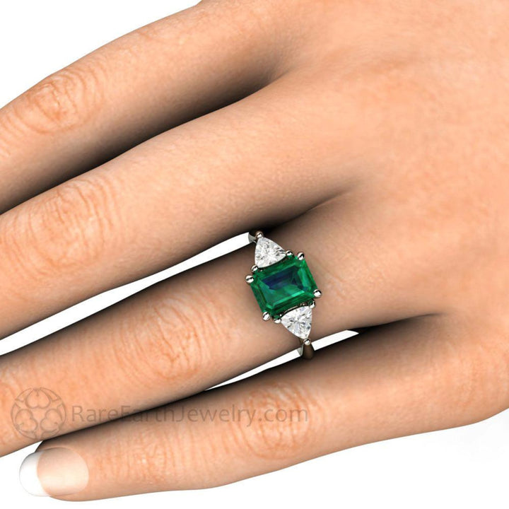 7x5 Emerald Cut Emerald on the Finger, Emerald Engagement Ring with Diamond trillions.