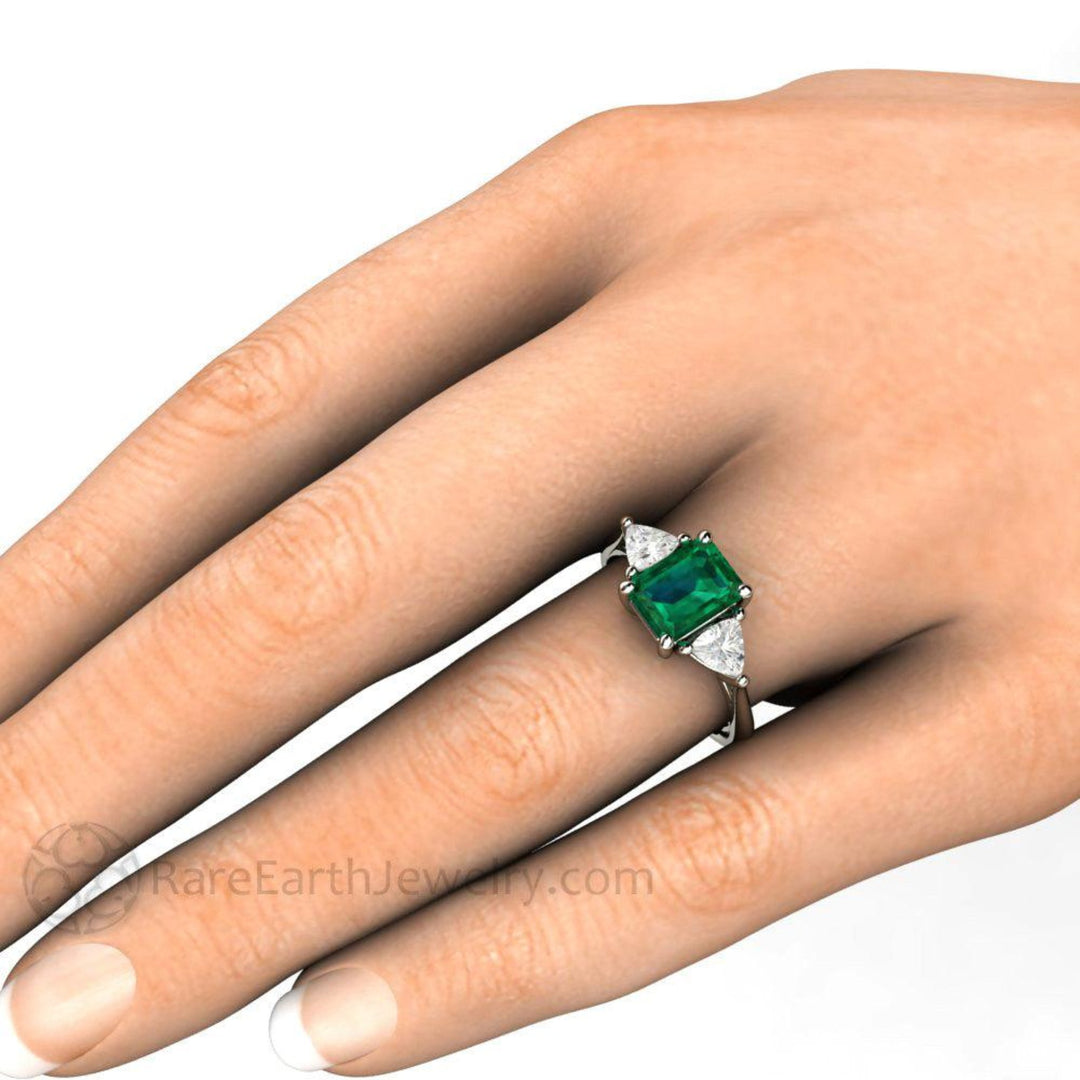 3 Stone Emerald Engagement Ring on the Hand | Emerald Cut May Birthstone Ring