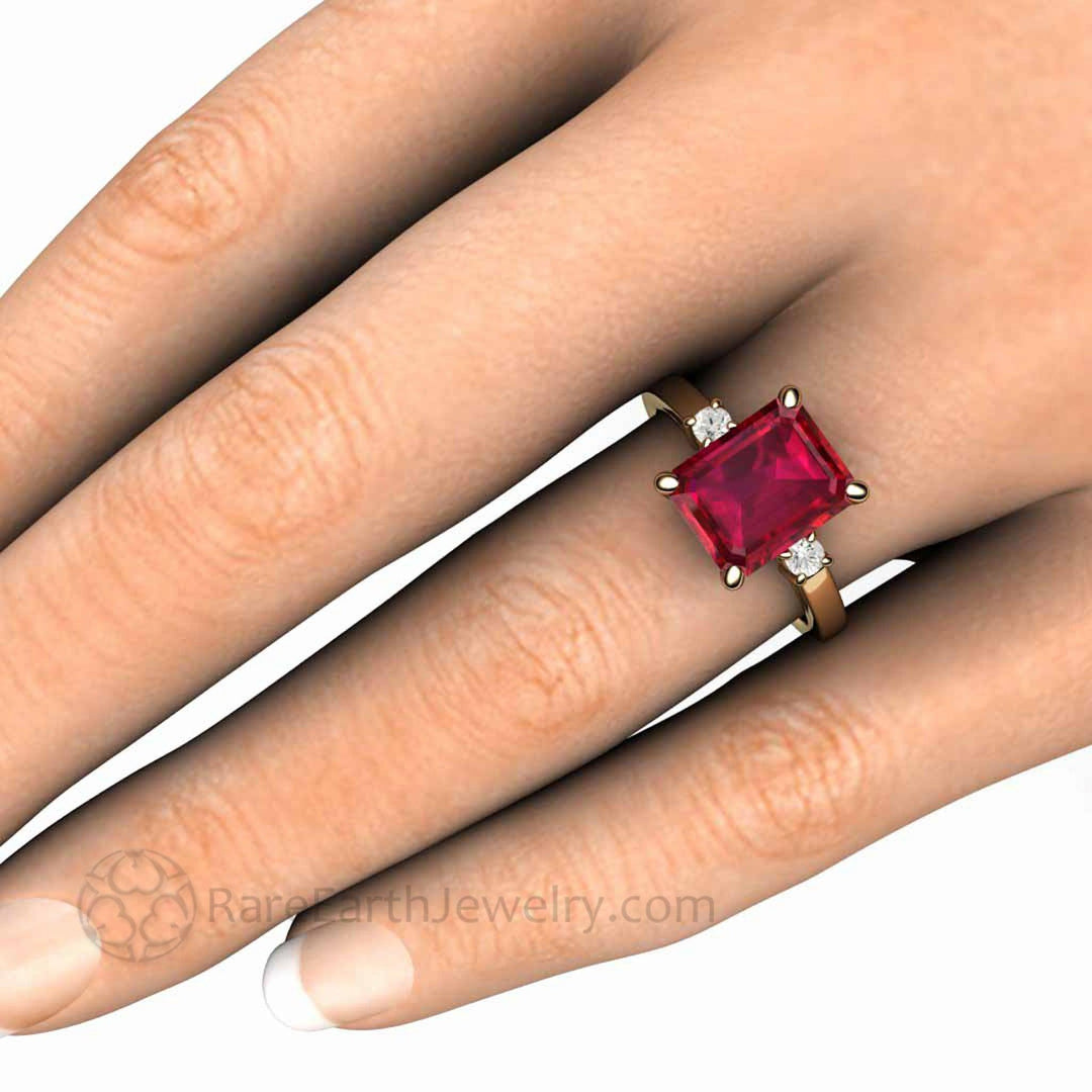 4ct Ruby Emerald Cut Engagement Ring, 3 Stone Design, Diamond Side Stones, on the Hand