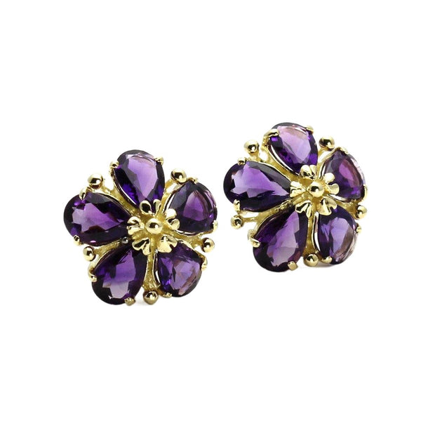 A pair of Amethyst flower shaped earrings in 14K Yellow Gold.  Each petal is set with a pear cut natural Amethyst around a gold center to make this floral design.  Unique February birthstone earrings.