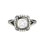 An Antique Style Moissanite Engagement Ring with an Art Deco Design, a cushion cut bezel set Moissanite ring.