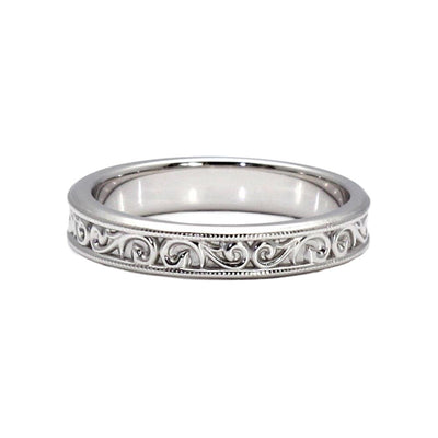 An antique style wedding band measuring 4mm wide with a pretty vintage inspired scroll and filigree design in white gold.igree Scroll Pattern
