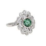 A natural Green Tourmaline ring with a vintage Art Deco design with diamonds in gold from Rare Earth Jewelry.