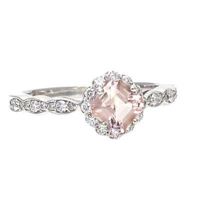 A vintage style Morganite engagement ring with an asscher cut natural morganite surrounded by a diamond halo and diamond accented scalloped band in gold or platinum.