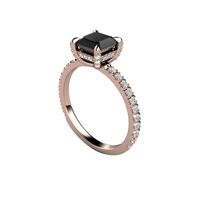 A unique black diamond engagement ring with a princess cut square natural black diamond and pave set diamonds.  There are hidden diamonds on the sides of the gallery, and claw shaped diamond prongs, shown in rose gold. 