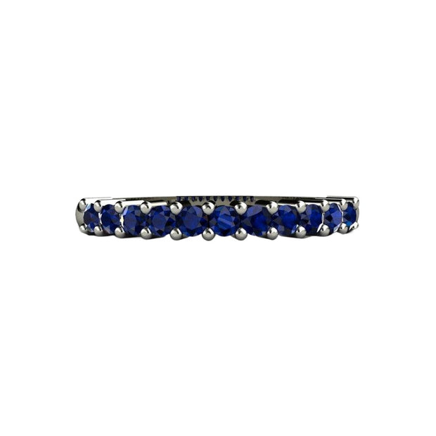 A blue sapphire anniversary band or wedding ring with round blue sapphires, september birthstone jewelry in gold or platinum.