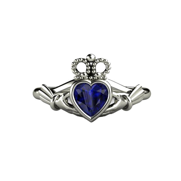 A Blue Sapphire Claddagh Ring with a Celtic inspired design and heart cut Blue Sapphire.  Irish Engagement ring or promise ring in gold or platinum from Rare Earth Jewelry.