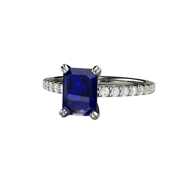 An emerald cut Blue Sapphire engagement ring in a classic solitaire setting with diamond accents and double prongs in gold or platinum from Rare Earth Jewelry.