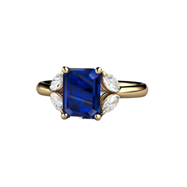An emerald cut Blue Sapphire engagement ring with marquise cut diamond side stones available in gold or platinum from Rare Earth Jewelry.