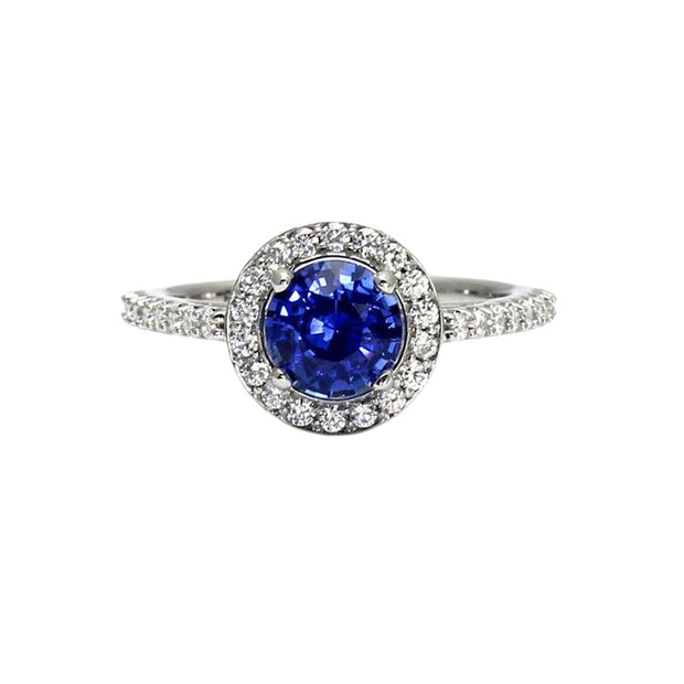 A round natural blue Sapphire engagement ring with a diamond halo design with pave set diamonds.  This sapphire ring has a natural sapphire from Ceylon, Sri Lanka with a lovely royal blue color.